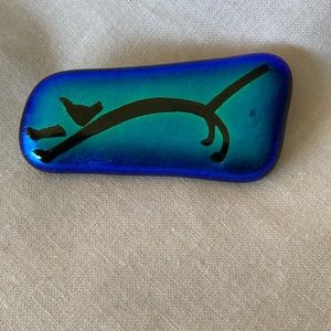 Oblong glass pin. Multi color with black cat
